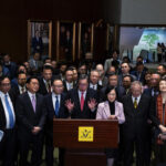 President of the Legislative Council Andrew Leung, center, and lawmakers attend a press conference following the passing of the Basic Law Article 23 legislation at the Legislative Council in Hong Kong, Tuesday, March 19, 2024. Hong Kong lawmakers unanimously approved a new national security law on Tuesday that grants the government more power to quash dissent, widely seen as the latest step in a sweeping political crackdown that was triggered by pro-democracy protests in 2019. (AP Photo/Louise Delmotte) © Provided by The Associated Press