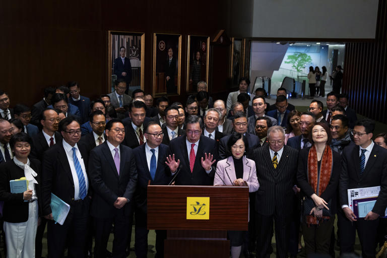 President of the Legislative Council Andrew Leung, center, and lawmakers attend a press conference following the passing of the Basic Law Article 23 legislation at the Legislative Council in Hong Kong, Tuesday, March 19, 2024. Hong Kong lawmakers unanimously approved a new national security law on Tuesday that grants the government more power to quash dissent, widely seen as the latest step in a sweeping political crackdown that was triggered by pro-democracy protests in 2019. (AP Photo/Louise Delmotte) © Provided by The Associated Press